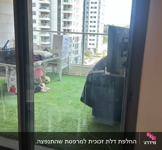 דלת זכוכית למרפסת עם נוף לבניינים